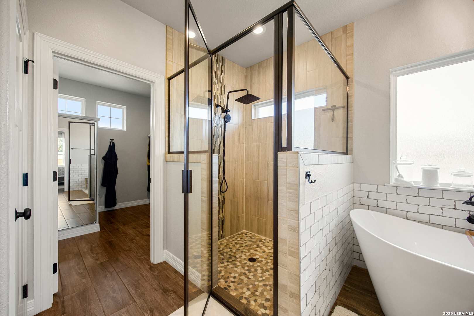 121 Western Way Adkins, TX 78101 - Photo 29 of 46 a bathroom with a bathtub and a shower
