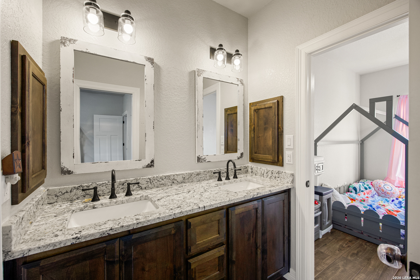 121 Western Way Adkins, TX 78101 - Photo 33 of 46 a bathroom with a sink double vanity and a mirror