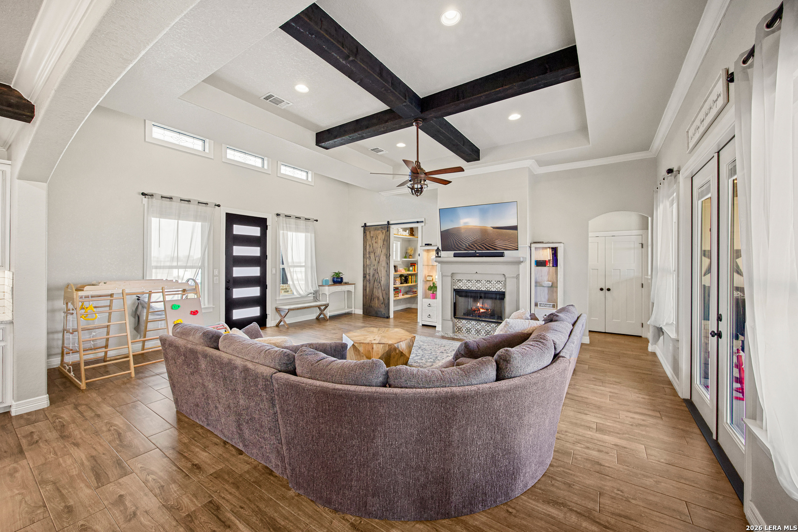 121 Western Way Adkins, TX 78101 - Photo 10 of 46 a living room with fireplace furniture and a wooden floor