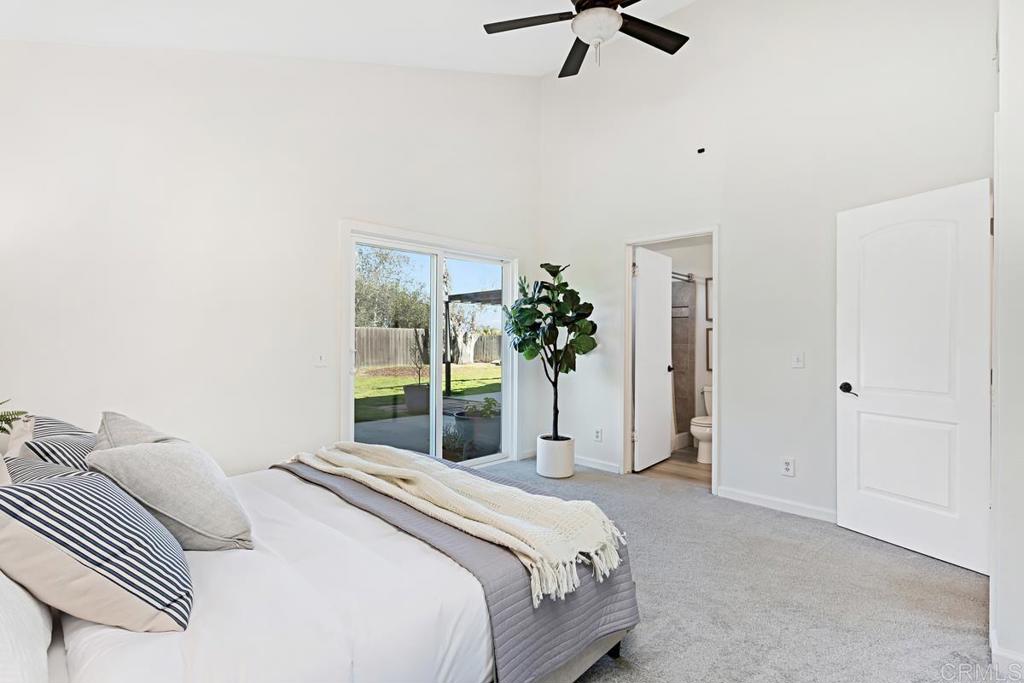 1081 Tylee Street Vista, CA 92083 - Photo 16 of 26 a bedroom with a bed and a potted plant