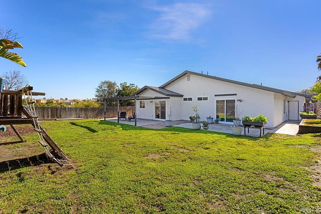 1081 Tylee Street Vista, CA 92083 - Photo 24 of 26 a view of a house with backyard and sitting area
