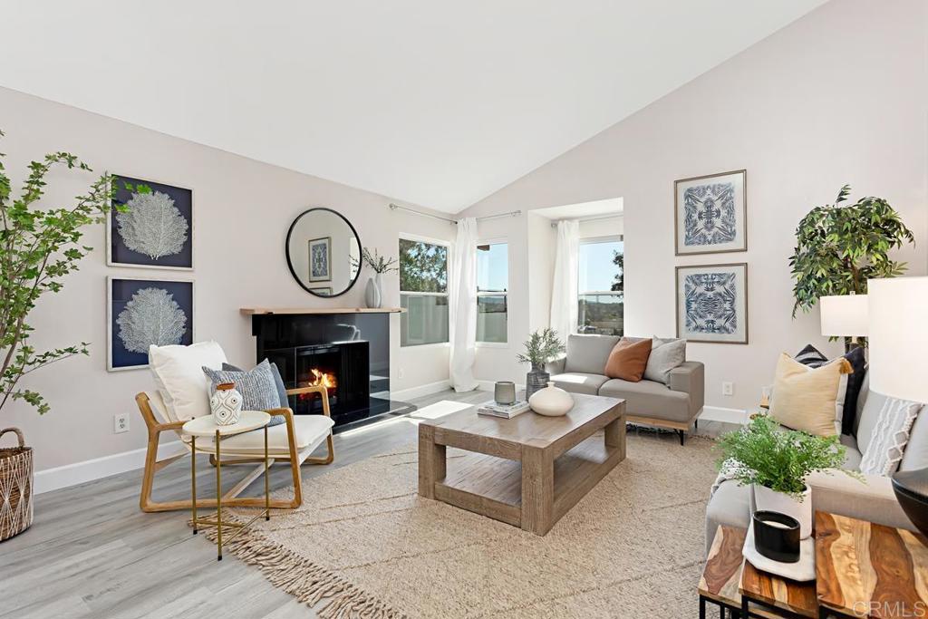 1081 Tylee Street Vista, CA 92083 - Photo 4 of 26 a living room with furniture a fireplace and a potted plant