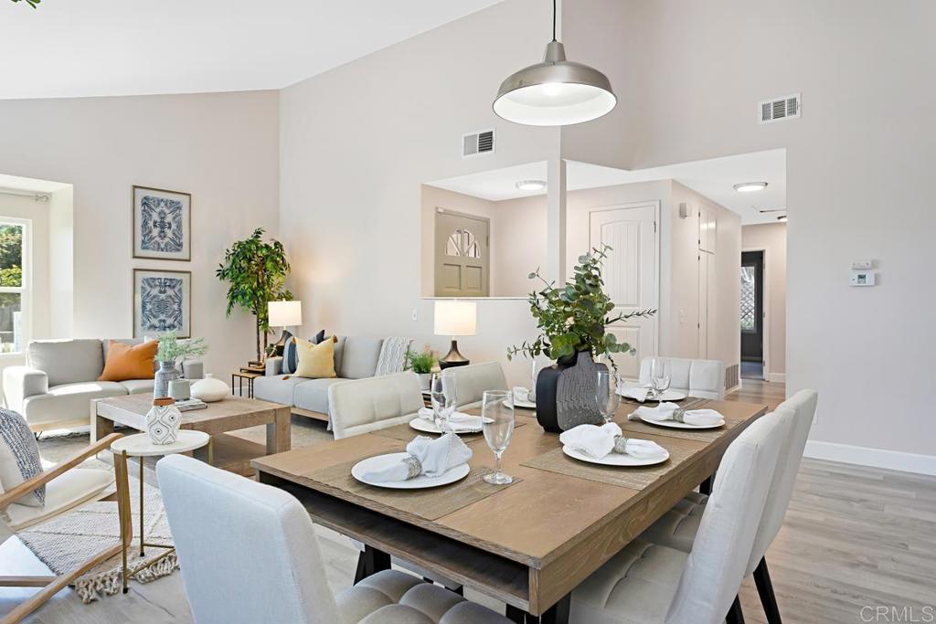 1081 Tylee Street Vista, CA 92083 - Photo 7 of 26 a view of a dining room with furniture wooden floor and chandelier