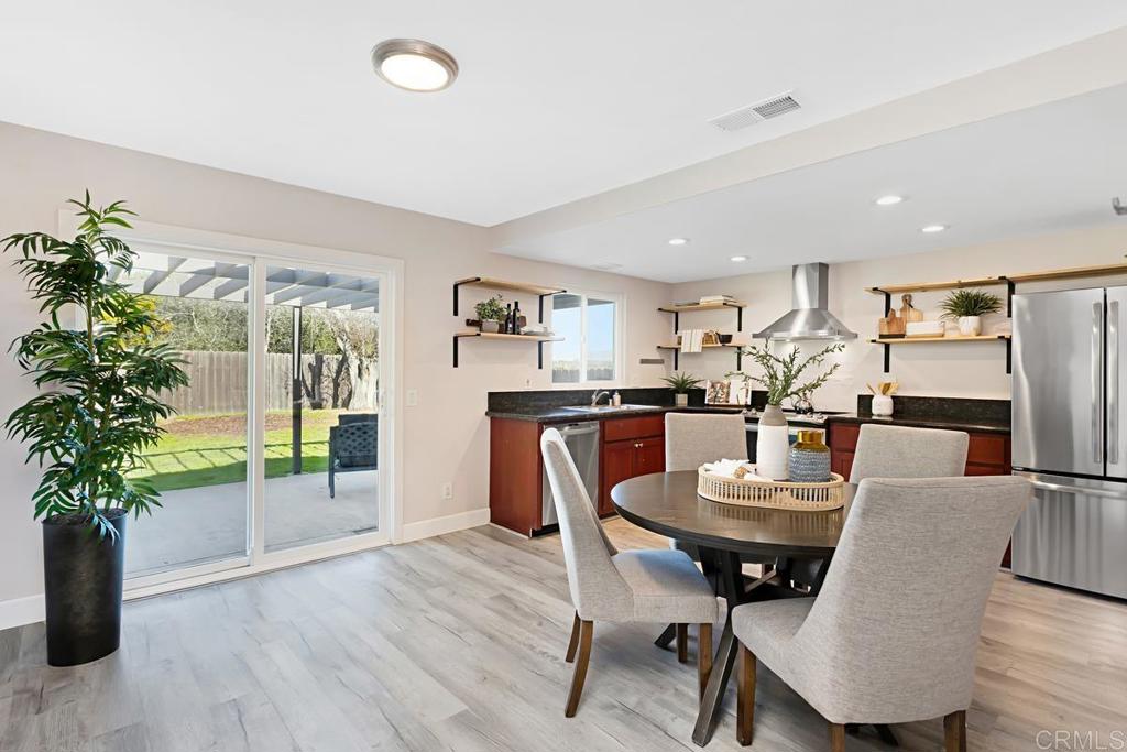 1081 Tylee Street Vista, CA 92083 - Photo 10 of 26 a view of a dining room with furniture window and wooden floor