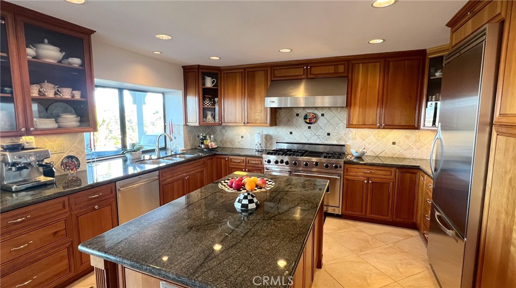 24394 Crestview Drive Newhall, CA 91321 - Photo 13 of 38 a kitchen with stainless steel appliances granite countertop a sink stove and refrigerator