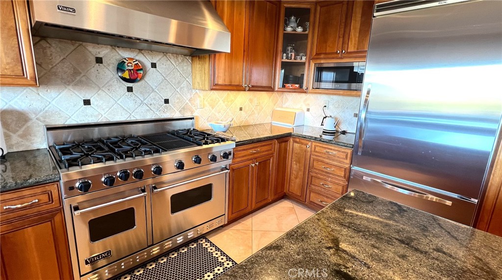 24394 Crestview Drive Newhall, CA 91321 - Photo 14 of 38 a kitchen with stainless steel appliances granite countertop a stove and a sink