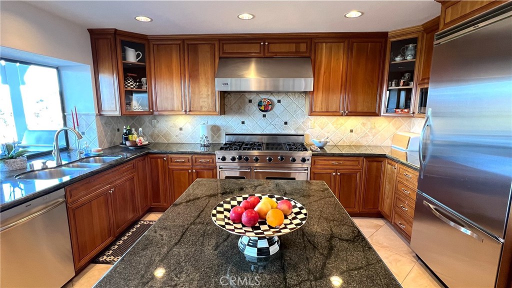 24394 Crestview Drive Newhall, CA 91321 - Photo 15 of 38 a kitchen with stainless steel appliances granite countertop a stove a sink and a microwave