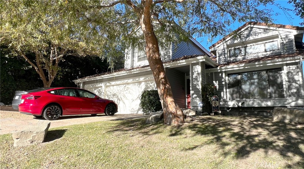 24394 Crestview Drive Newhall, CA 91321 - Photo 2 of 38 a view of a backyard with a table and chairs