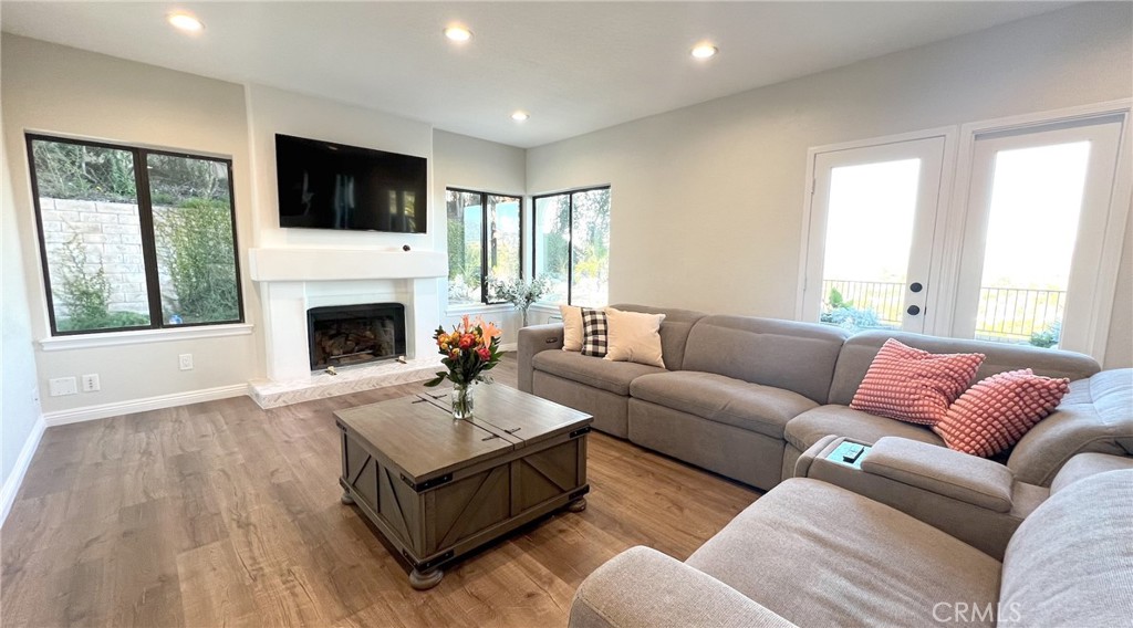 24394 Crestview Drive Newhall, CA 91321 - Photo 25 of 38 a living room with furniture fireplace and window