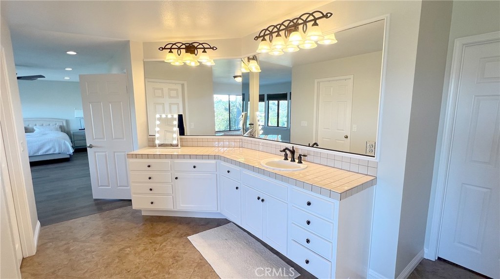 24394 Crestview Drive Newhall, CA 91321 - Photo 35 of 38 a bathroom with a sink double vanity and a mirror