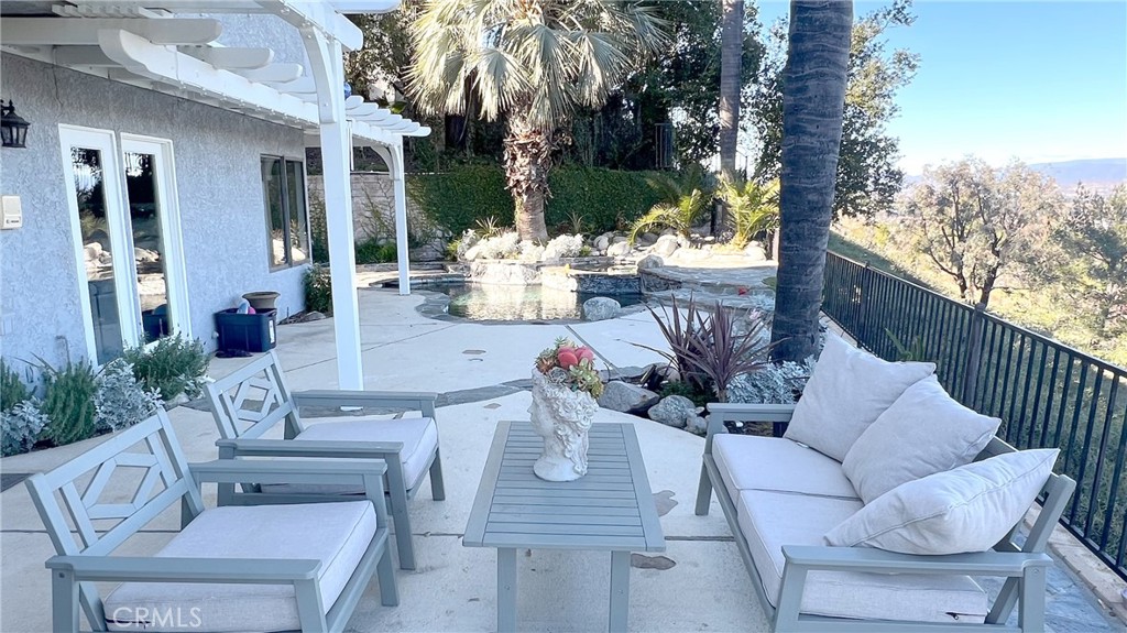 24394 Crestview Drive Newhall, CA 91321 - Photo 7 of 38 a view of an outdoor dining space with a table and chairs