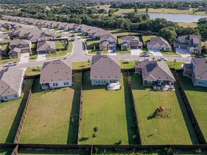 an aerial view of residential houses with outdoor space and swimming pool