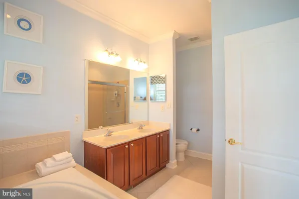a bathroom with a tub sink and mirror