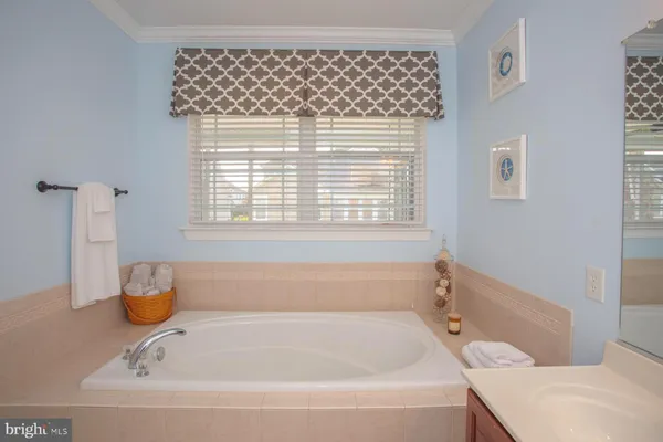 a bathroom with a bathtub and a window