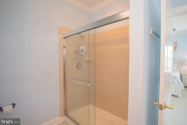 a bathroom with a glass shower door