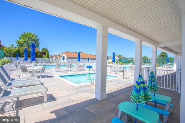 a swimming pool with outdoor seating and yard