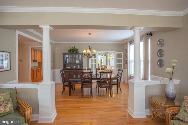 a view of a dining room with furniture and chandelier