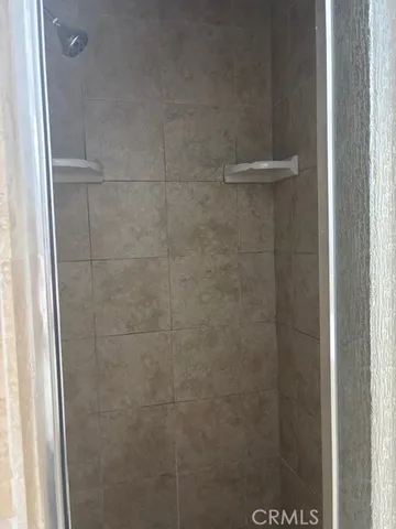 a bathroom with a glass shower door