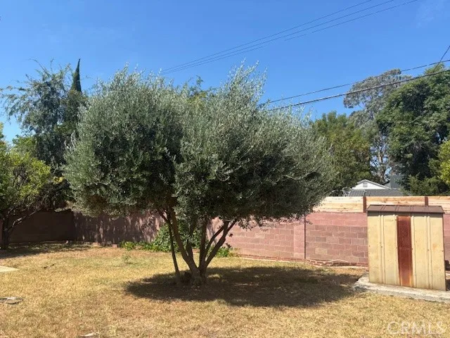 a view of yard with wooden fence