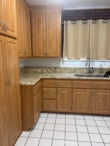 a kitchen with a sink window and cabinets