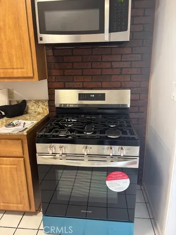 a stove top oven sitting inside of a kitchen