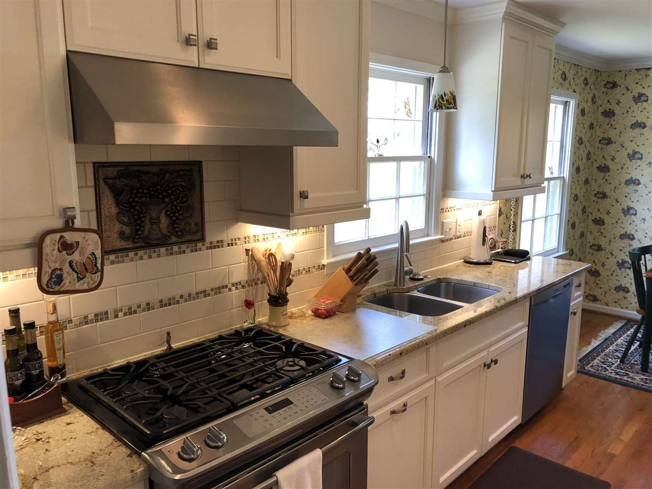 3907 Converse Drive Raleigh, NC 27609 - Photo 8 of 30 Lovely white custom kitchen, gas range and gas convection oven, warming tray, wall electric convection oven, built in microwave. Lots of cabinet storage and separate pantry. Granite counter tops. Gormet Kitchen