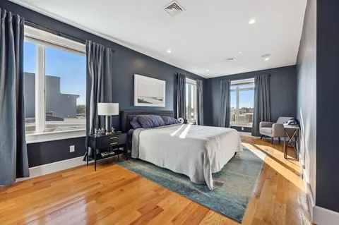 a spacious bedroom with a large bed and a large window