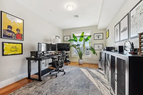a view of a workspace with furniture and a potted plant