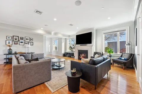 a living room with furniture a fireplace and a flat screen tv