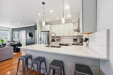 a large kitchen with a table and chairs