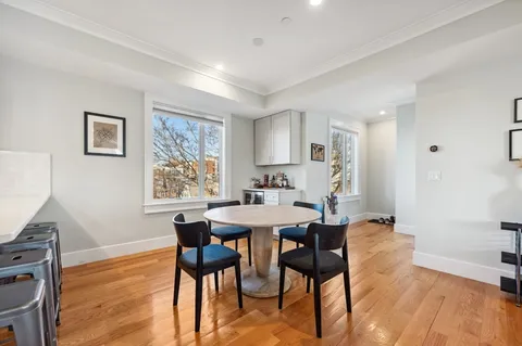 a view of a dining room with furniture and wooden floor