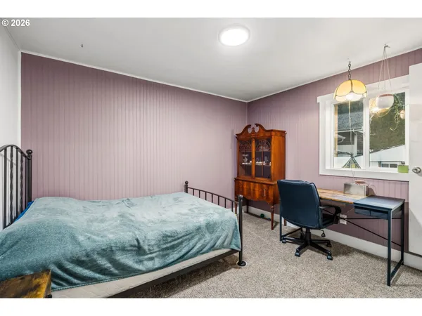 a bedroom with a bed and a desk