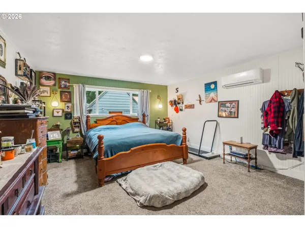 a bedroom with furniture and a large window