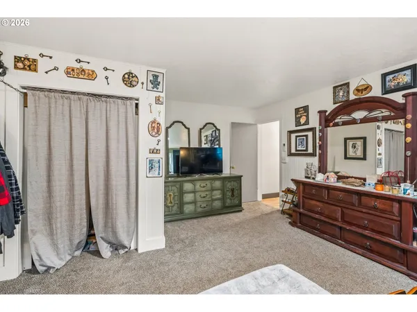 a living room with furniture and a baby crib