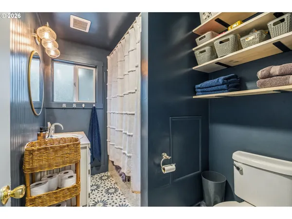 a bathroom with a toilet a sink and mirror