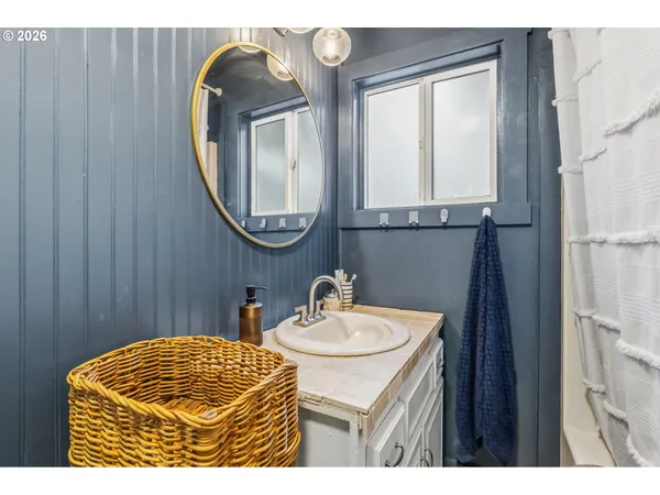 a bathroom with a sink mirror and vanity