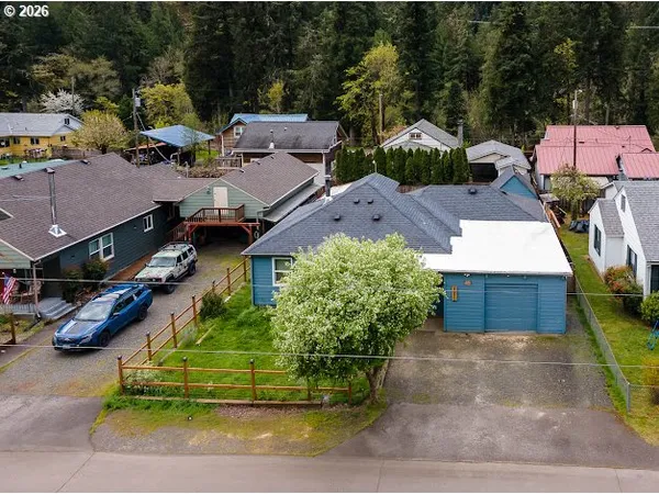 an aerial view of a house with a garden and parking space