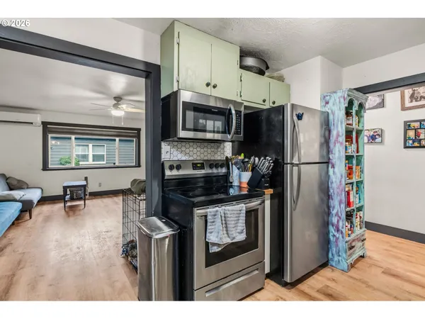 a kitchen with stainless steel appliances granite countertop a refrigerator and a stove top oven