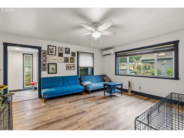 a living room with furniture and painting on the wall