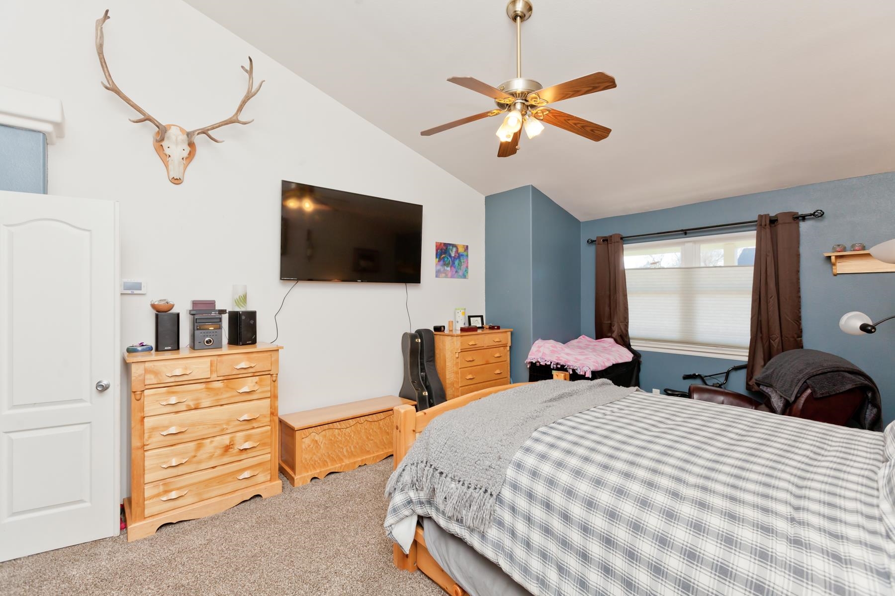 173 Sierra Drive Fruita, CO 81521 - Photo 16 of 40 a bedroom with a bed and a flat screen tv