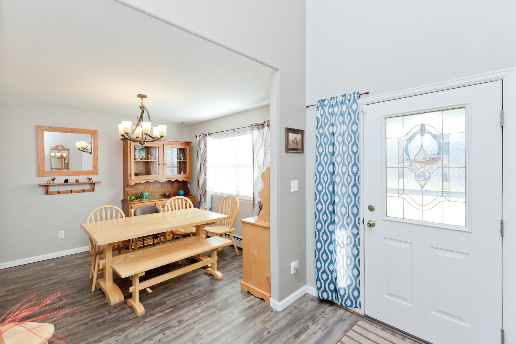 173 Sierra Drive Fruita, CO 81521 - Photo 2 of 40 a bedroom with furniture and a chandelier