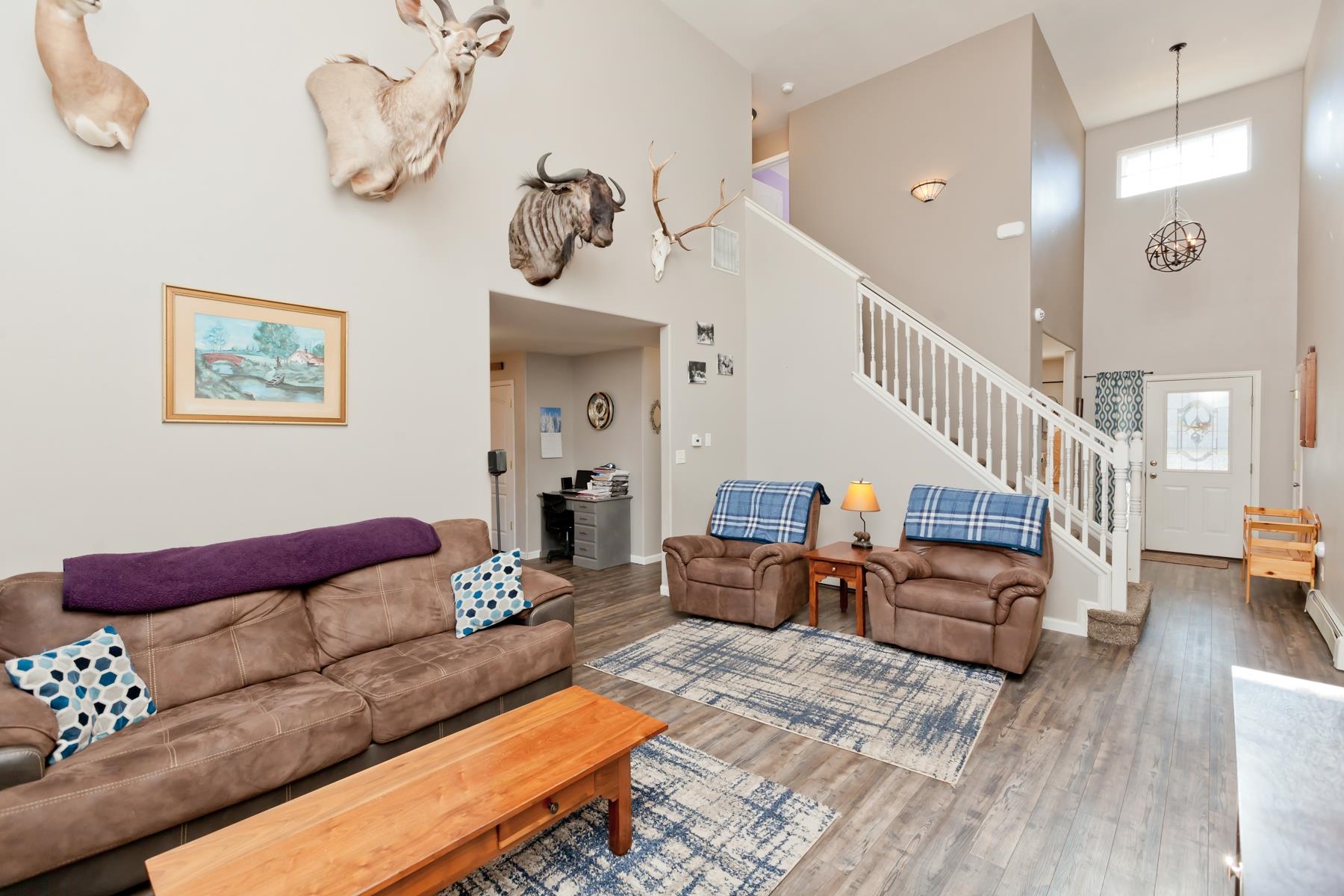 173 Sierra Drive Fruita, CO 81521 - Photo 4 of 40 a living room with furniture stairs and a chandelier