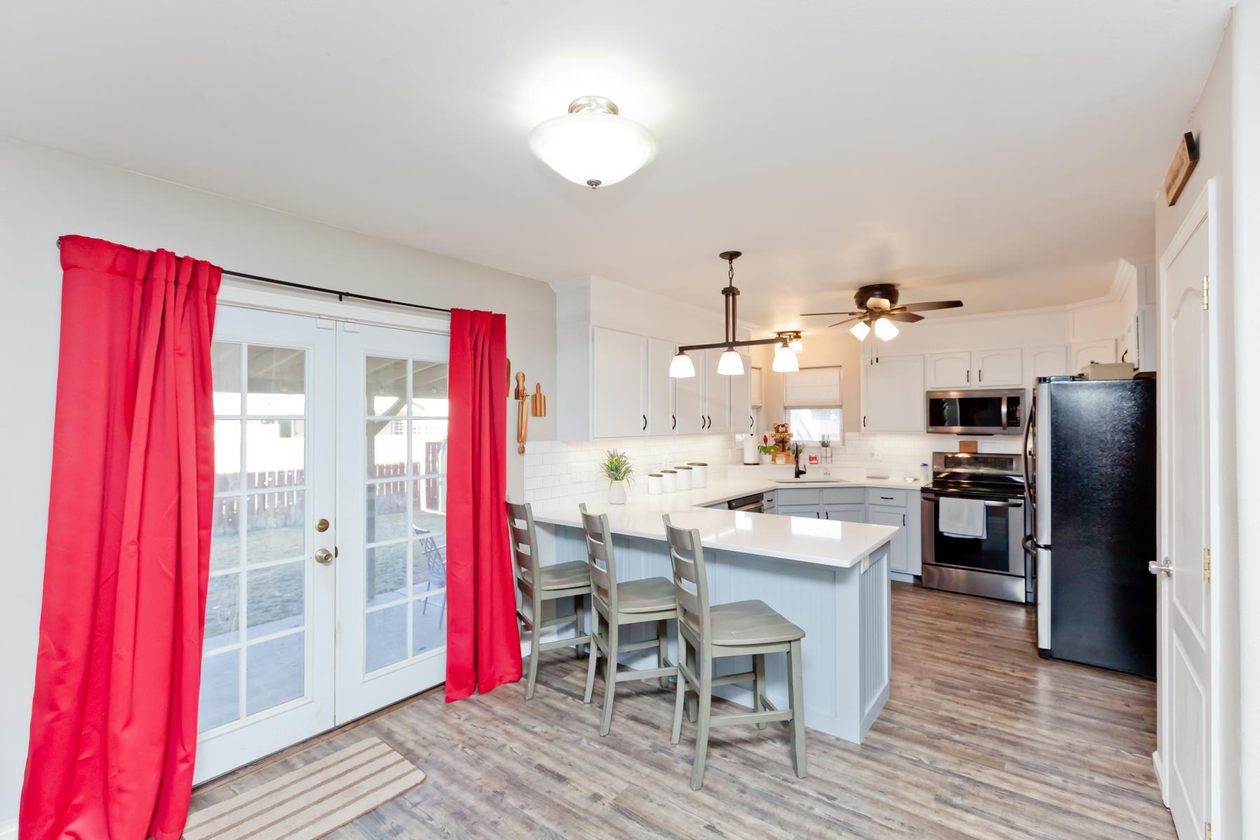 173 Sierra Drive Fruita, CO 81521 - Photo 9 of 40 a kitchen with stainless steel appliances granite countertop a dining table and chairs with wooden floor
