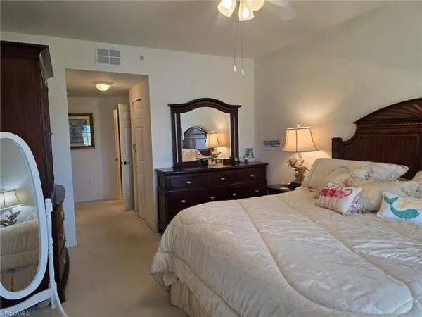 a bedroom with a bed and a potted plant