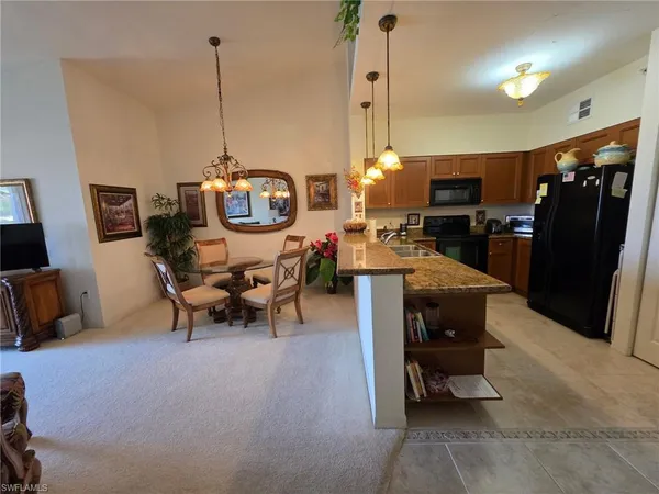 a living room with furniture a flat screen tv and a table
