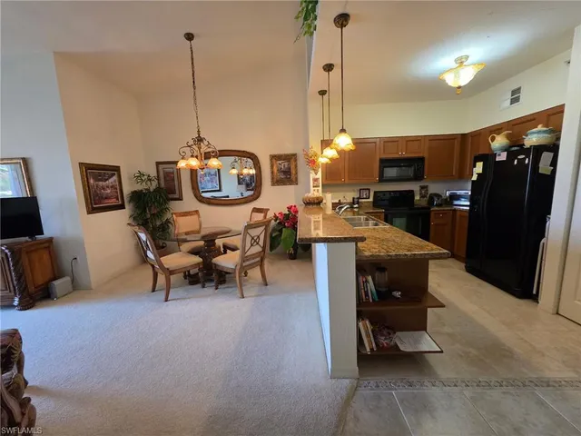 a living room with furniture a flat screen tv and a table