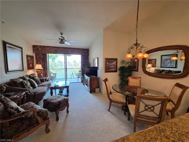 a living room with furniture a flat screen tv and a window