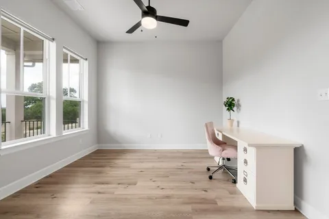 a view of a hallway with entryway wooden floor and front door
