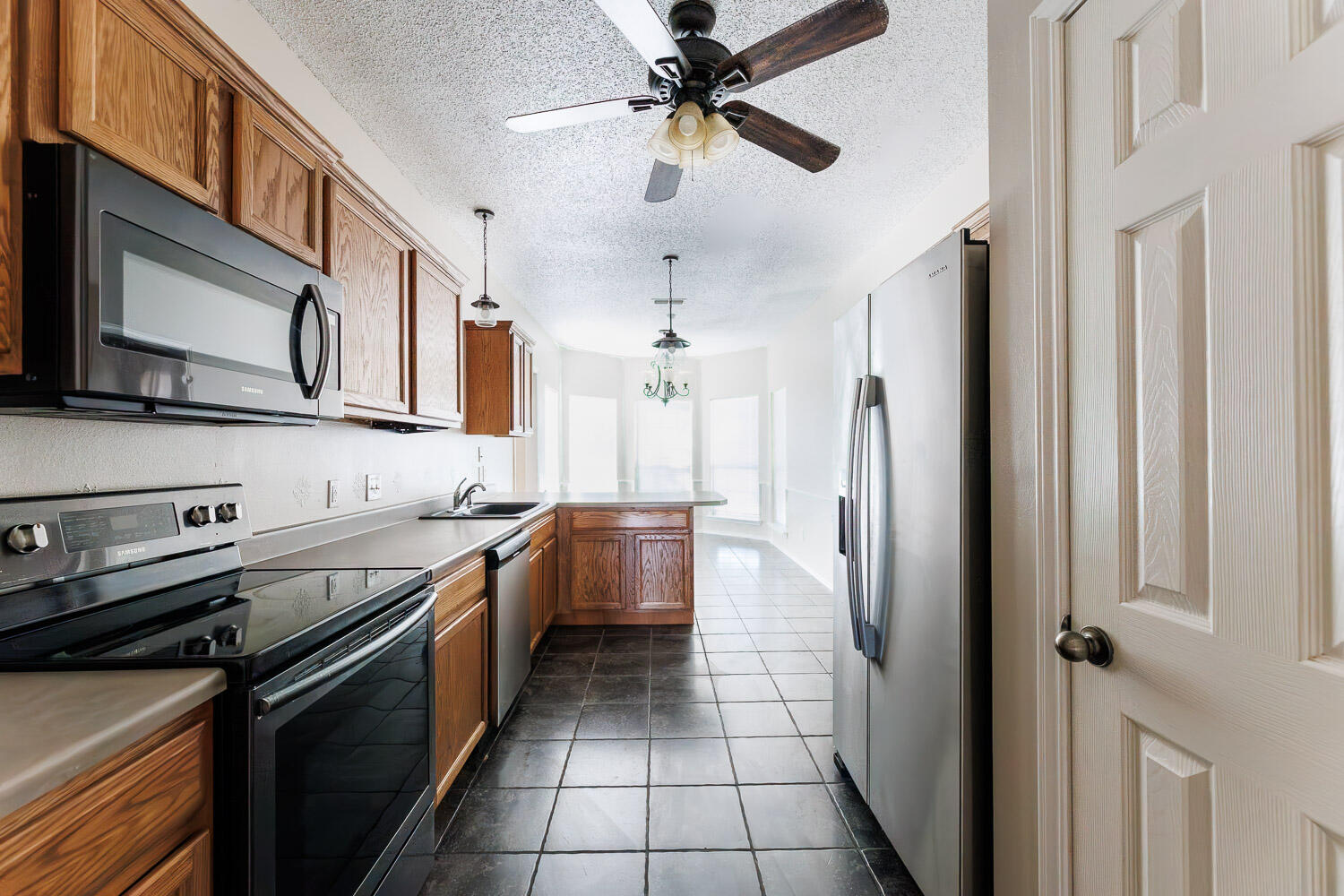6704 87th Street Lubbock, TX 79424 - Photo 11 of 49 a kitchen with stainless steel appliances granite countertop a sink and a refrigerator