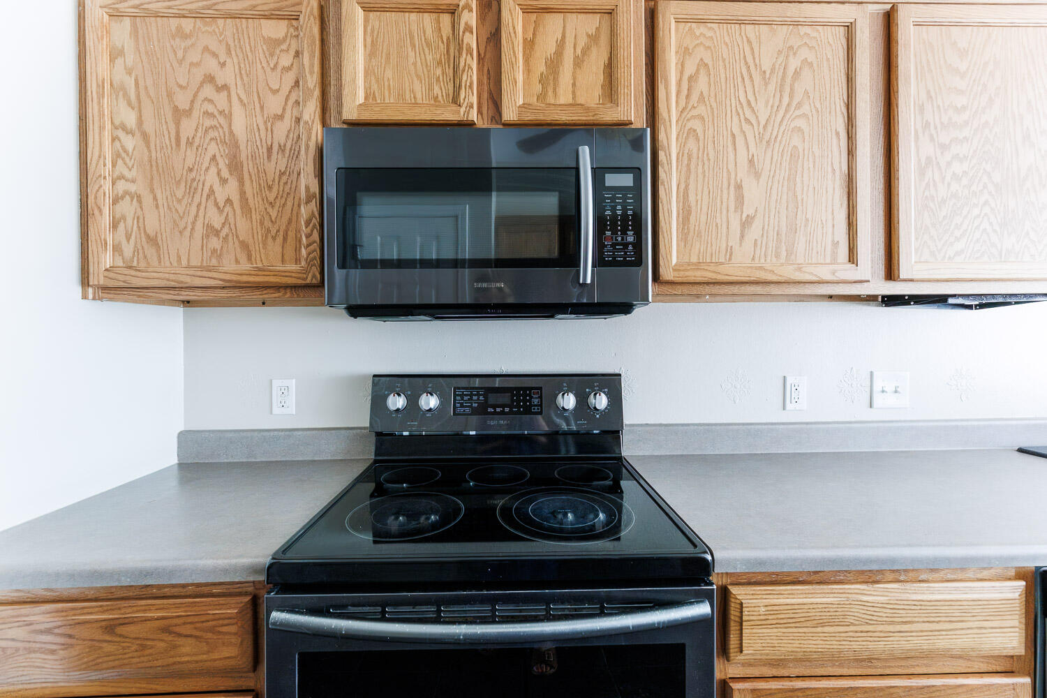 6704 87th Street Lubbock, TX 79424 - Photo 13 of 49 a stove top oven sitting inside of a kitchen